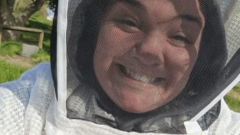 Mel Sarmento in a beekeeping uniform