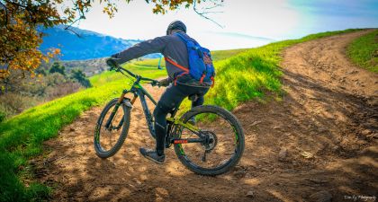 Mountain biker turning a sharp corner on a trail