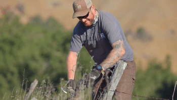 Open Space Technician Stephen removes barbed wire fencing from MOCR