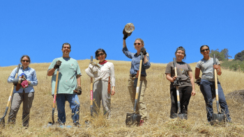 Land Stewards pose for a photo among the grass at Furtado Barn