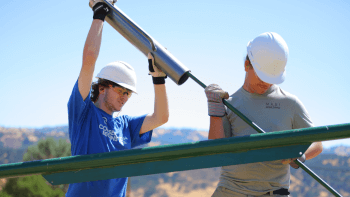 Student Conservation Association students install t-posts into the ground at MOCR