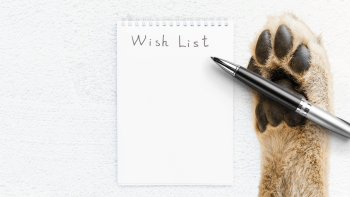 Wildlife Wish List Featured Image: A paw writing with a pen on a notepad