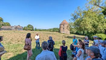 A group of individuals tour a farm in the Paris countryside