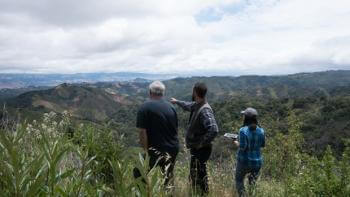 Linda Kwong in the field looking out at a landscape