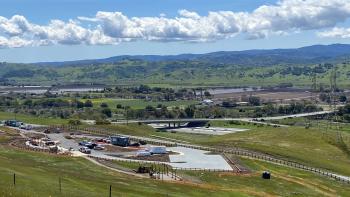 A view of a parking lot under construction at MOCR from the green hillside