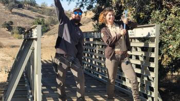 Two OSA staff members celebrate the completion of renovating a bridge at Coyote Valley OSP