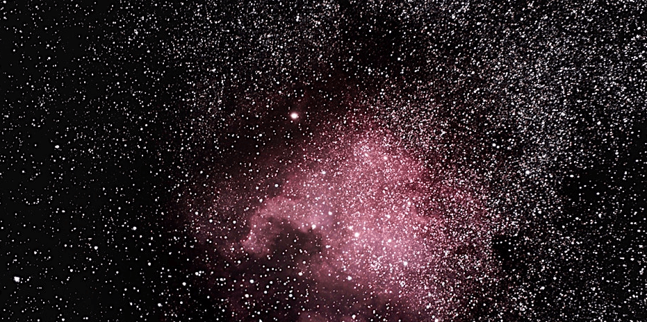 Black night sky with pink nebula and white stars throughout.