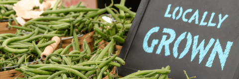 Green beans sit on a table at a local farmer's market